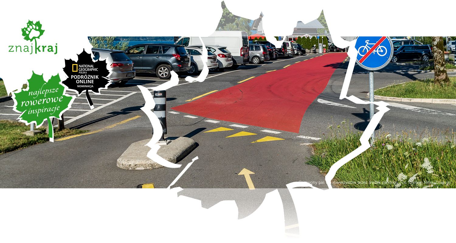 Czerwony pas dla rowerzystów przez środek parkingu