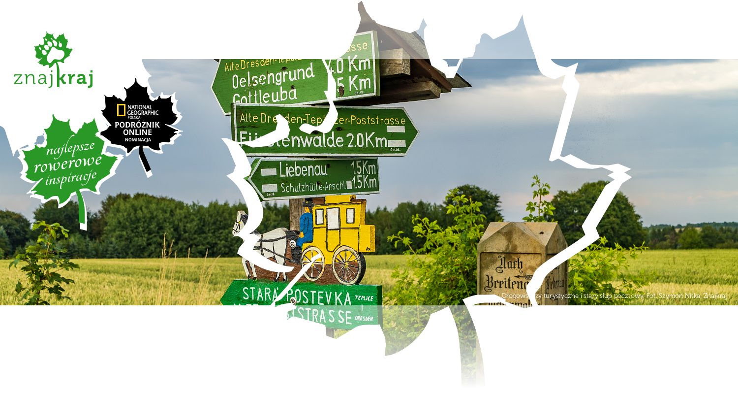 Drogowskazy turystyczne i stary słup pocztowy