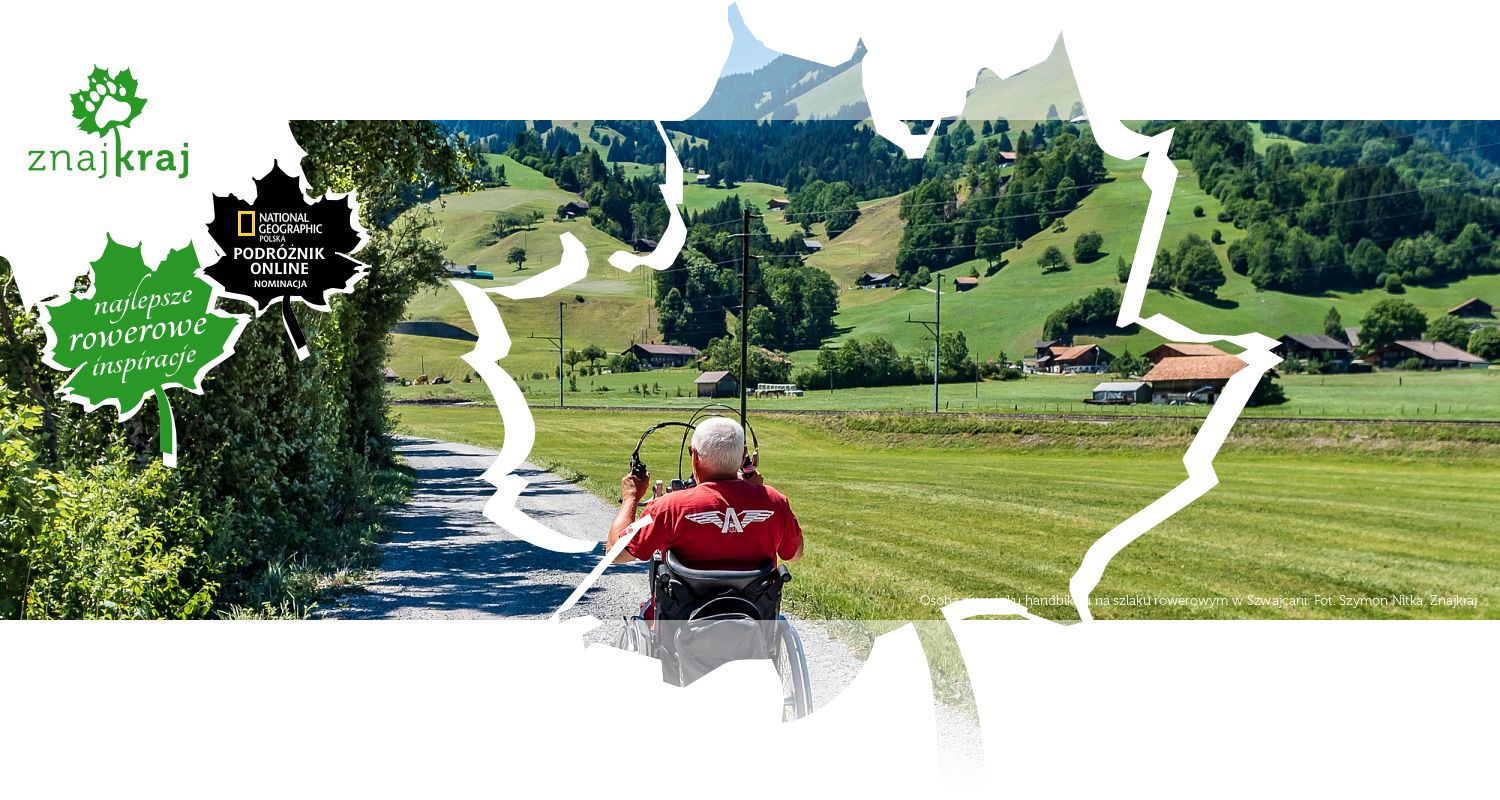Osoba na wózku handbike&#039;u na szlaku rowerowym w Szwajcarii
